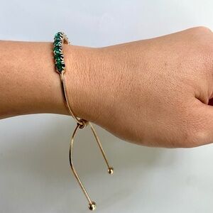 Emerald green jewels and golden bracelet